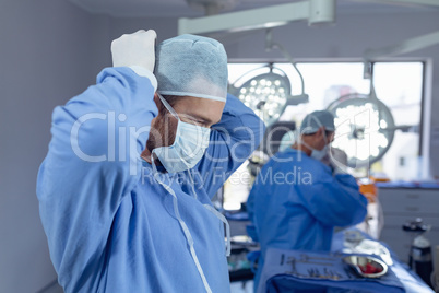 Male surgeon wearing surgical mask in operation room at hospital