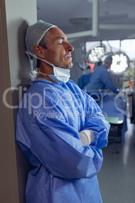 Upset male surgeon standing in operation room at hospital