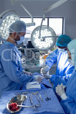 Surgeons performing surgery in operation theater