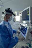 Female surgeon using the medical monitor in operation theater at hospital