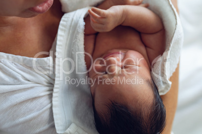 Mother holding her newborn baby child after labor in the ward at hospital