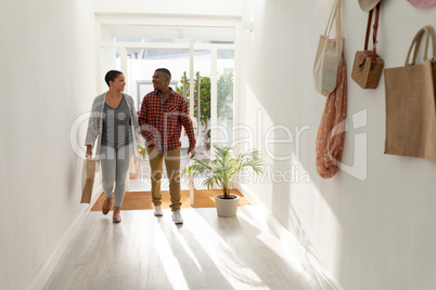 Couple entering hand in hand their home