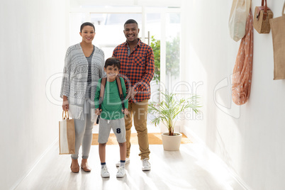 Family standing together near door at home