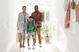 Family standing together near door at home