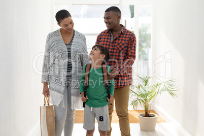 Family standing together near doorway at home