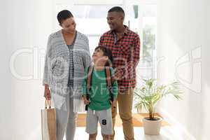 Family standing together near doorway at home