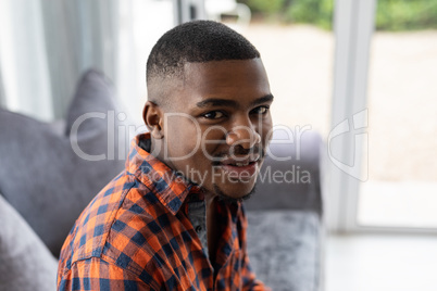 Man relaxing on a sofa in living room at home