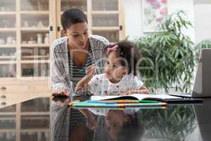 Mother helping her daughter with her homework on a table