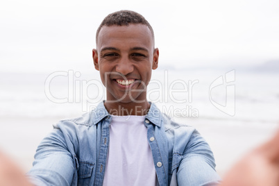 Man smiling at beach on a sunny day