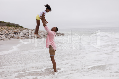 Father and daughter playing together on the beach