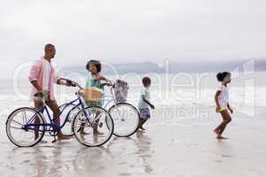 Family walking with bicycle on a sunny day