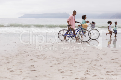 Family walking with bicycle on a sunny day