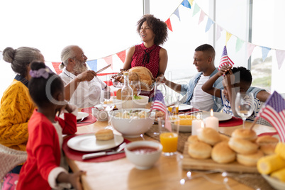 Multi-generation family having food together on a dining table