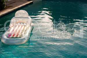 Inflatable tube floating in a swimming pool in backyard