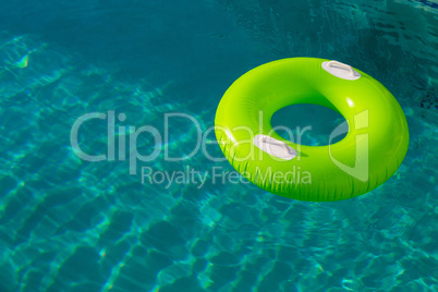 Inflatable tube floating in a swimming pool in backyard