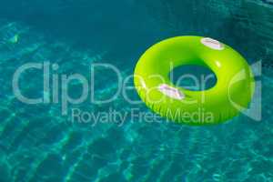 Inflatable tube floating in a swimming pool in backyard