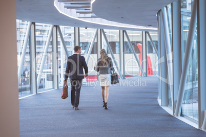 Business people walking together in the corridor at modern office building