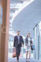 Business people walking together in the corridor at modern office building