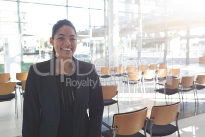 Smiling businesswoman standing in conference room