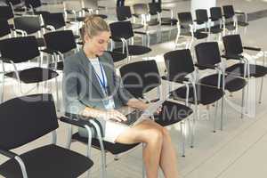 Businesswoman working on laptop in conference room