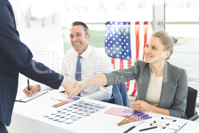 Businessman shaking businesswoman hands during interview session