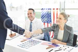 Businessman shaking businesswoman hands during interview session