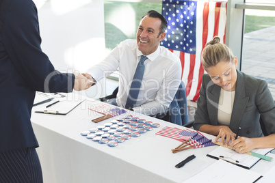 Diverse business people sat next to desk and smiling to applicant