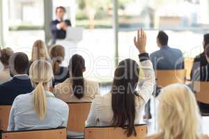 Mature Caucasian male executive doing speech in conference room, answering question