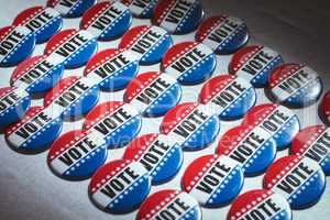 Electoral pins in the colors of the US flag on table