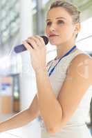 Young Caucasian businesswoman doing a speech in conference room