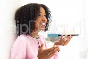 Young pretty African-american employee talking on phone