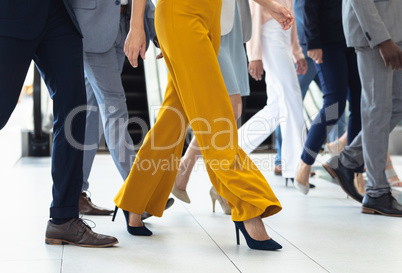 Diverse executives walking in the same direction in hall