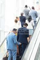 Diverse business people on escalator