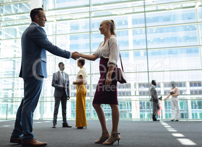Caucasian diverse executives shaking hands in modern office