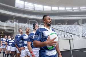 Group of Male rugby players entering stadium in a row for match
