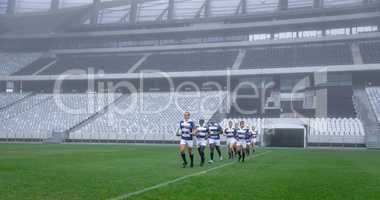 Group of male rugby players entering stadium in a row for match