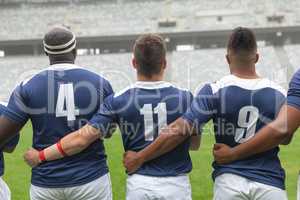 Diverse Male rugby players taking pledge together in stadium