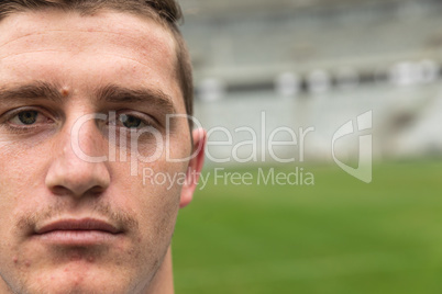 Caucasian rugby player looking at camera in the stadium