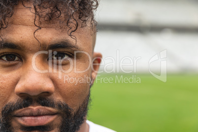 African american rugby player looking at camera in the stadium