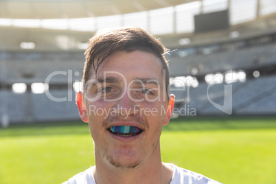 Male rugby player with mouth guard in stadium