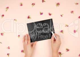 black chalk frame with an inscription hello summer and two femal