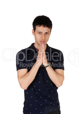 Young handsome man in a black shirt with hands folded