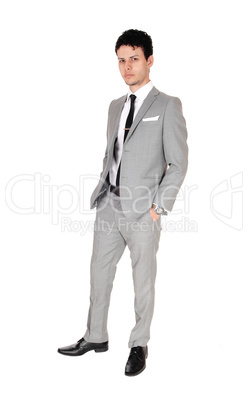 Handsome young man standing in gray suit