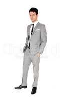 Handsome young man standing in gray suit