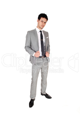 Business man standing relaxed is a gray suit