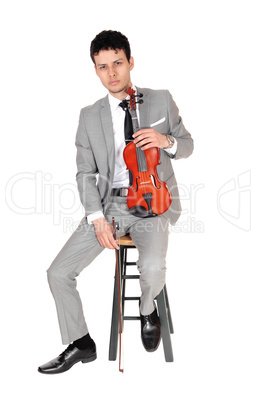 Young man sitting with his violin in his hands