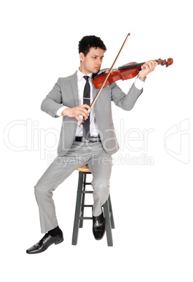 A full body image of young man playing the violin