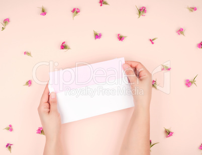 female hands open white paper envelope, in the middle a letter