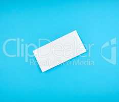white rectangular paper envelope on a blue background