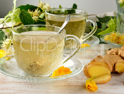 transparent cup with tea from ginger and linden